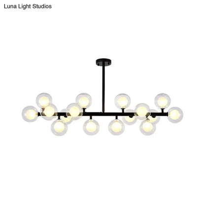 Black metal chandelier with 16 clear glass globe bulbs designed for contemporary living room island lighting by DecorBites