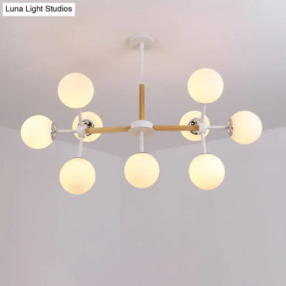 DecorBites™ contemporary globe chandelier with white glass globes and wooden crossbar for dining room hanging light