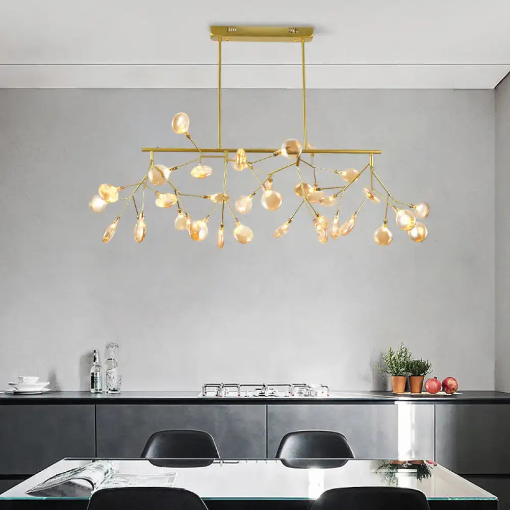 Gold-toned DecorBites heracleum island pendant light with branching arms and teardrop glass bulbs for modern dining rooms