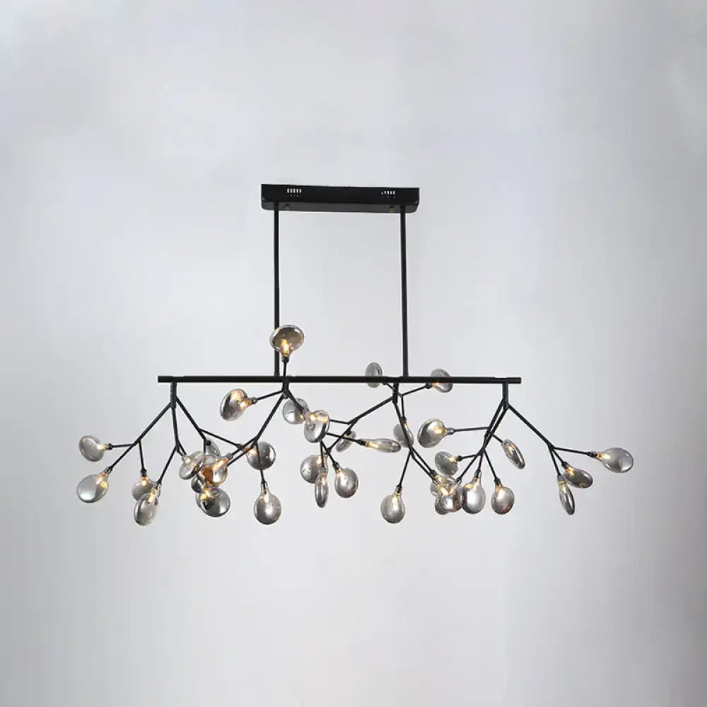 Black metal heracleum island pendant light with branching arms and clear glass teardrop bulbs for modern dining rooms