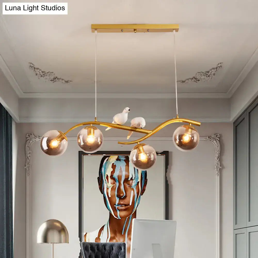 Gold-toned DecorBites™ contemporary metal branch hanging lamp with five glass globes smoke grey cognac and bird decor
