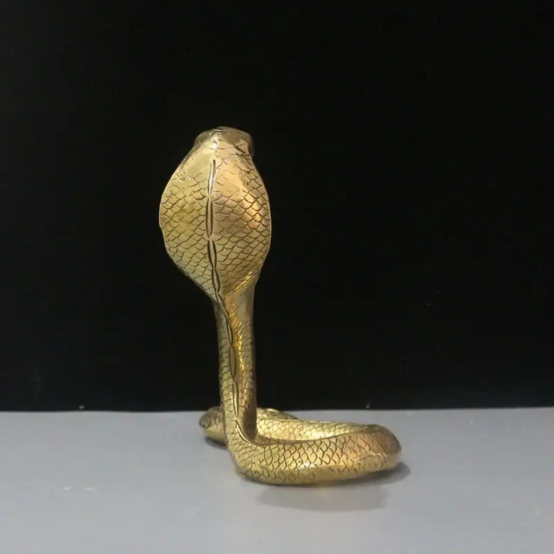 Golden brass cobra zodiac snake statue with detailed scales and raised hood for living room decor