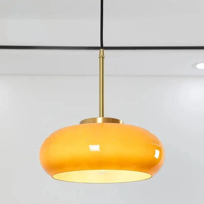 DecorBites™ copper pendant light with sleek amber glass shade, brass stem, and black cord for elegant lighting