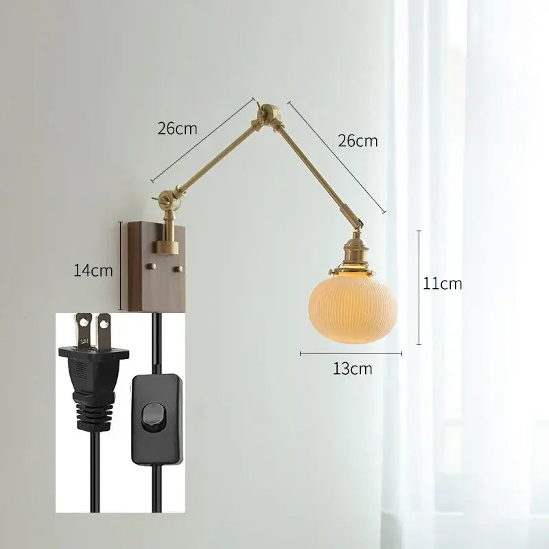 Brass-finished decorbites copper swing arm wall lamp with adjustable arm and ribbed frosted glass globe for bedroom use