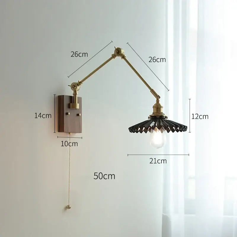 Brass-finished decorbites copper swing arm wall lamp with black fan-shaped metal shade and exposed bulb for bedroom