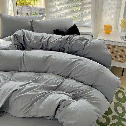 DecorBites™ gray cotton bedding set with duvet cover and matching pillows featuring a soft, slightly wrinkled texture