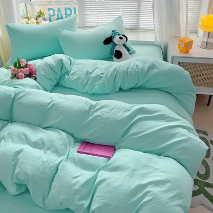Mint green cotton bedding set with duvet cover and pillowcases featuring a plush stuffed dog on bed by DecorBites