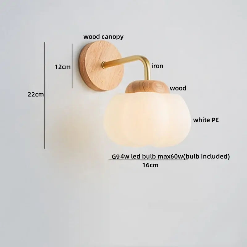 A decorbites cotton led wall lamp with natural wood canopy, brass iron accents, and a white pe glass globe sconce