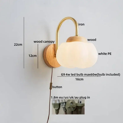 A warm-toned decorbites cotton led wall lamp with brass iron arm wooden base and soft white cotton led wall shade for bedroom