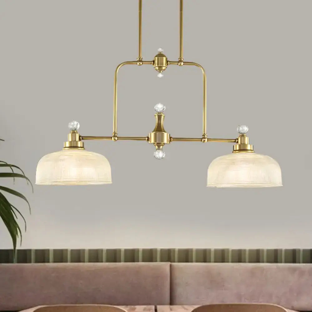Brass-finished industrial pendant light kit with clear prismatic glass shades and crystal accents for kitchen island lighting
