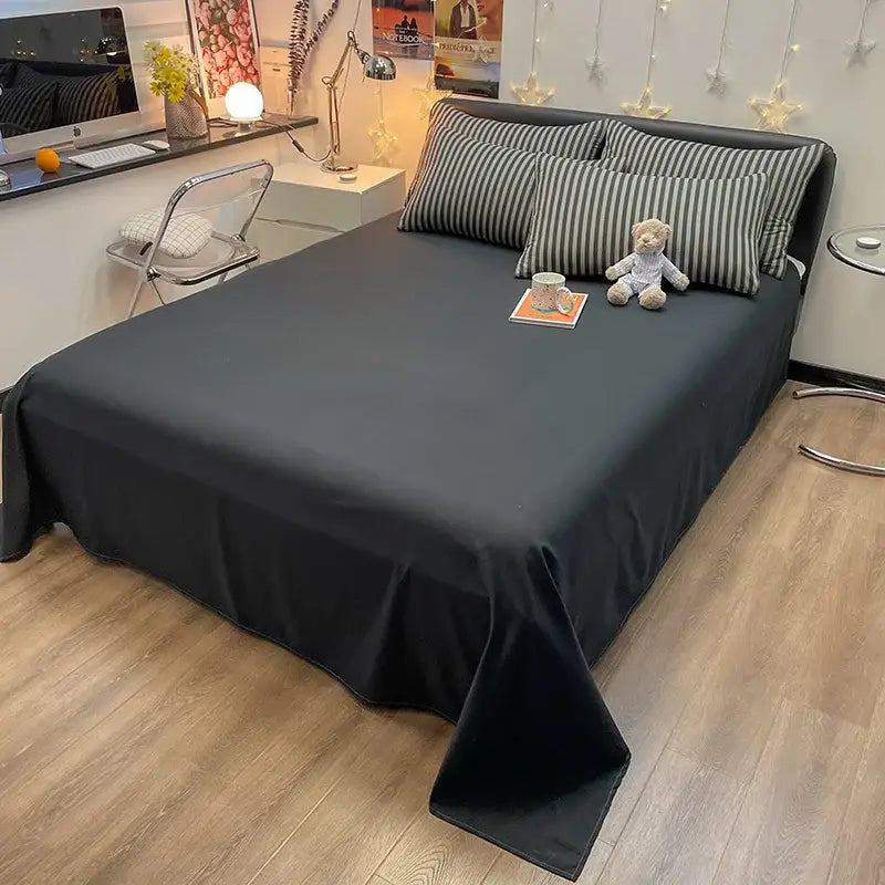 Black satin bed sheet with smooth flowing drape and sheen from DecorBites cozy nordic plaid 1pc duvet cover set