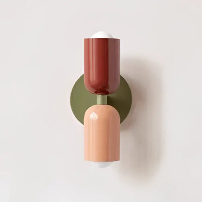A modern decorbites cream double head wall lamp featuring a two-toned terracotta and blush pink sconce with olive green backplate