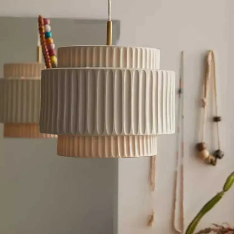 Cream-colored ceramic decorbites cream wind led chandelier with fluted tiers and gold-toned hanging rod for dining room
