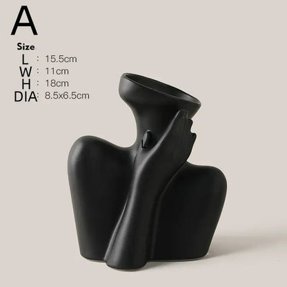 Black ceramic human vase with abstract flowing form holding its own head for modern home decor by DecorBites