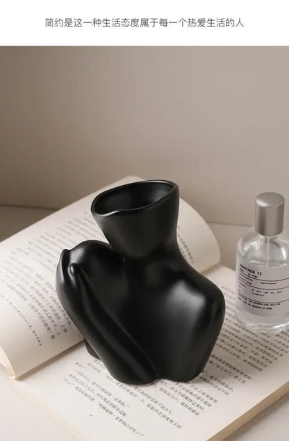 Black glossy ceramic human vase by DecorBites™ featuring an abstract stylized torso for modern home decor