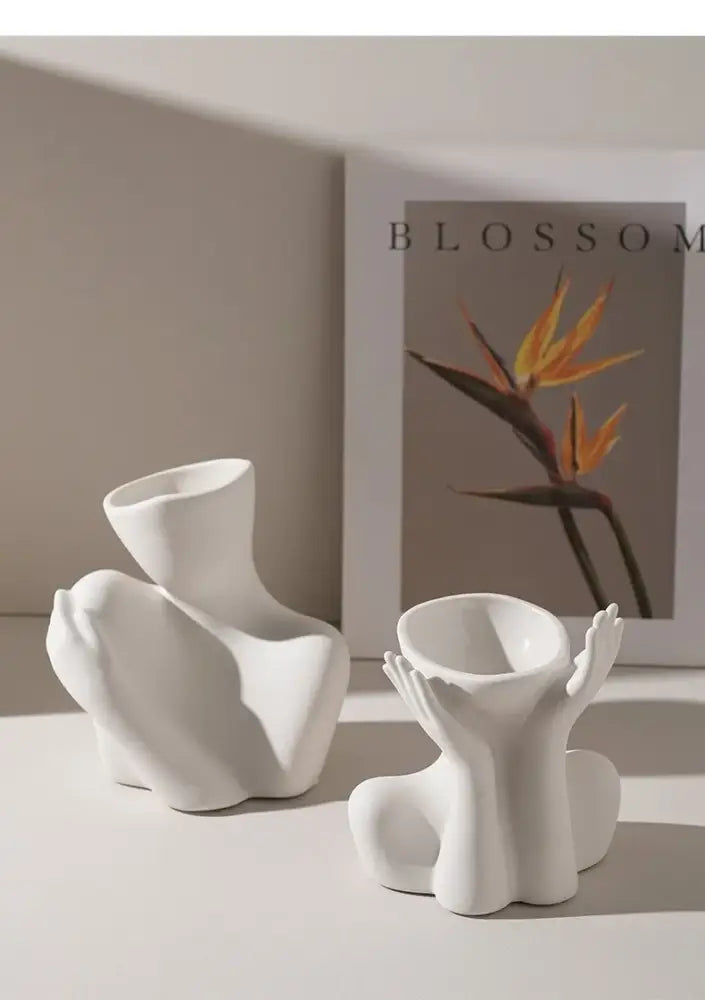 White ceramic human vase with abstract forms and cup openings for creative home decor by decorbites