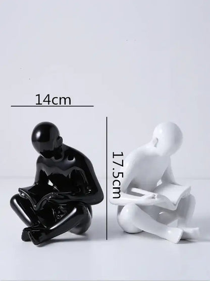Black and white glossy resin creative ceramics sculpture by decorbites creative featuring abstract seated figures with books