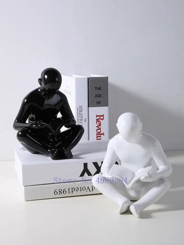 Glossy black and white ceramic figurines of seated human forms by Decorbites creative ceramics for living room decor