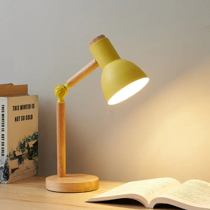 Yellow creative nordic table lamp with wooden base and articulated arm ideal for bedside reading and study lighting