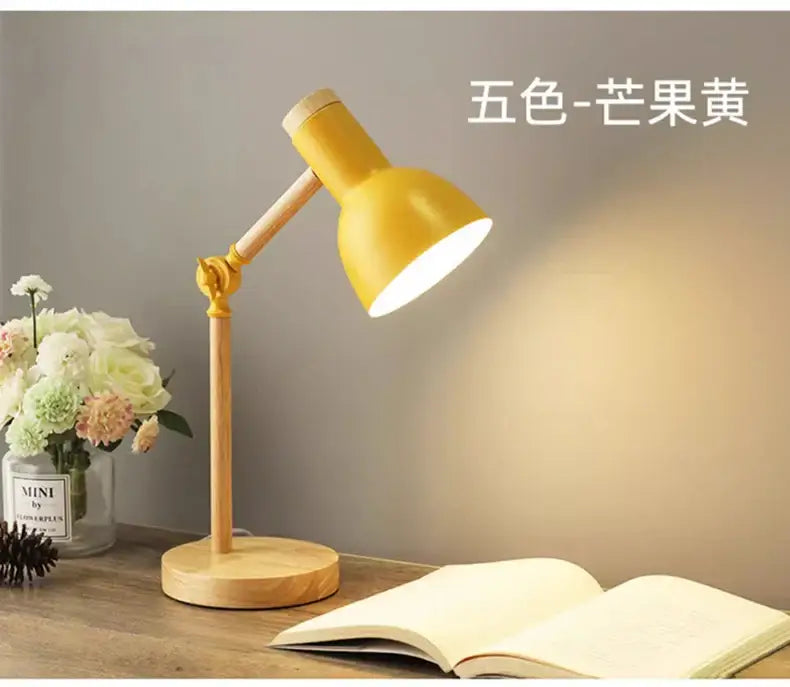 Yellow metal nordic table lamp with wooden base and adjustable arm for bedside desk and reading use