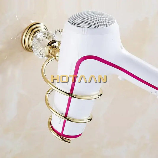 White hair dryer with magenta accent mounted in gold-toned decorbites crystal bathroom spiral stand holder