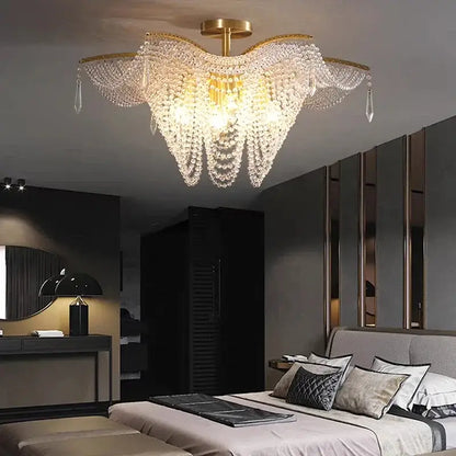 A golden decorbites crystal butterfly tassel chandelier with cascading crystal beads for elegant living room lighting