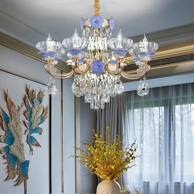 A decorbites crystal candle chandelier with gold-toned metal arms, clear crystal droplets, and purple glass flowers