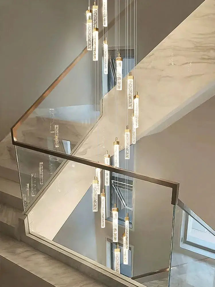 Modern nordic decorbites crystal ceiling chandelier with slender cylindrical glass pendants and gold-toned metal caps