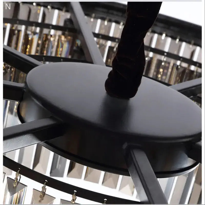 Black circular stool with matte finish and modern design complementing DecorBites crystal ceiling chandelier