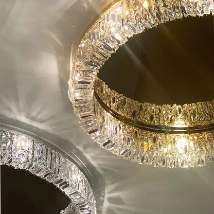 A decorbites crystal ceiling lamp featuring two golden concentric rings with faceted clear crystals for luxe lighting
