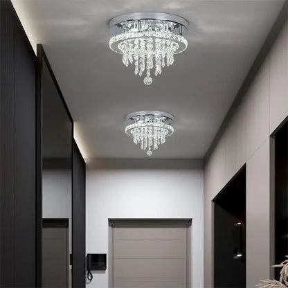 Two identical decorbites crystal ceiling lamps feature chrome bases and cascading clear glass prisms with smart LED control