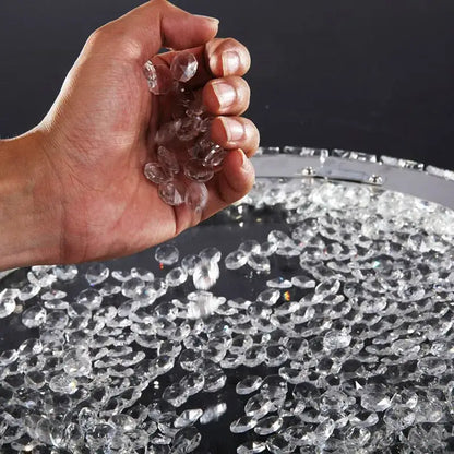 Hand holding clear faceted crystal beads for decorbites crystal ceiling light with LED bulbs for living room and bedroom use