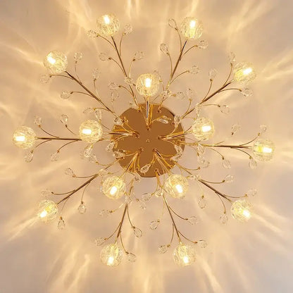 Gold-toned decorbites crystal ceiling light with crystal branches and spherical glass globes for modern luxury spaces