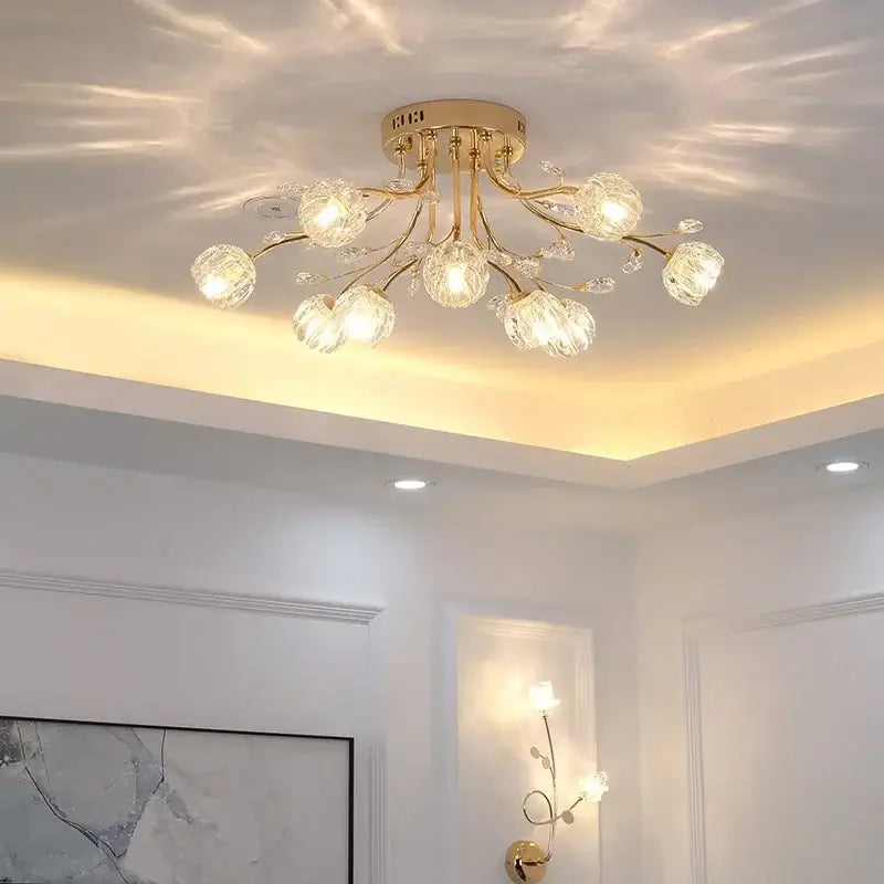 Gold-toned decorbites crystal ceiling light with multiple crystal globe shades in a branching design by Samsarah Lighting