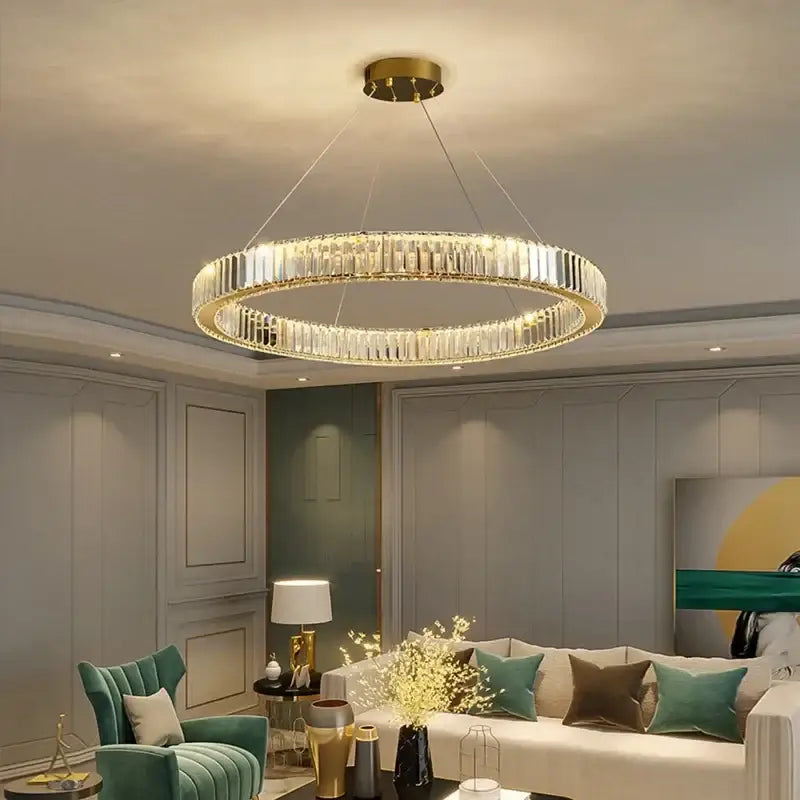 A modern decorbites crystal ceiling pendant chandelier featuring double-ring clear crystal facets and gold-toned metal accents