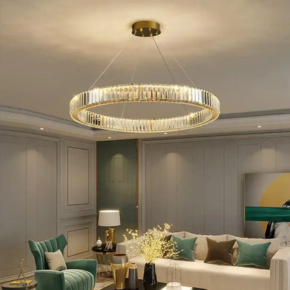 A modern decorbites crystal ceiling pendant chandelier featuring double-ring clear crystal facets and gold-toned metal accents