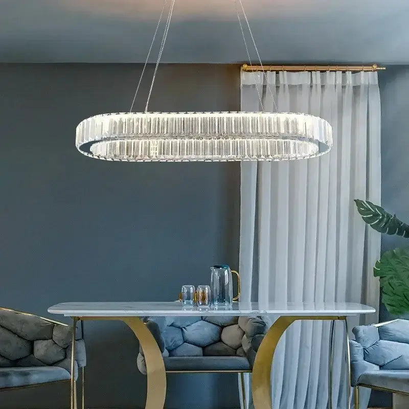 A modern double-layered decorbites crystal ceiling pendant with sleek oval design and hanging chains for luxury decor