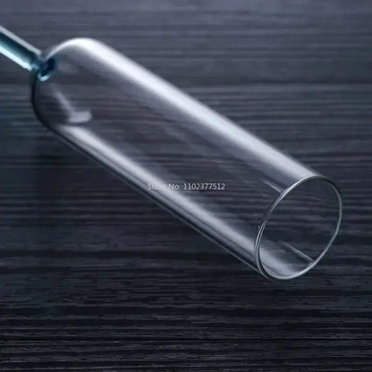 Clear glass cylindrical container with narrow neck featuring decorbites crystal champagne wine glass design