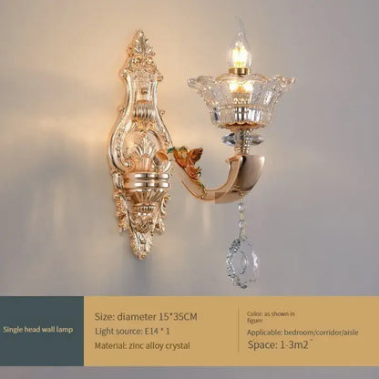 Gold-toned ornate decorbites crystal chandelier wall sconce with crystal accents and teardrop pendant for living and dining