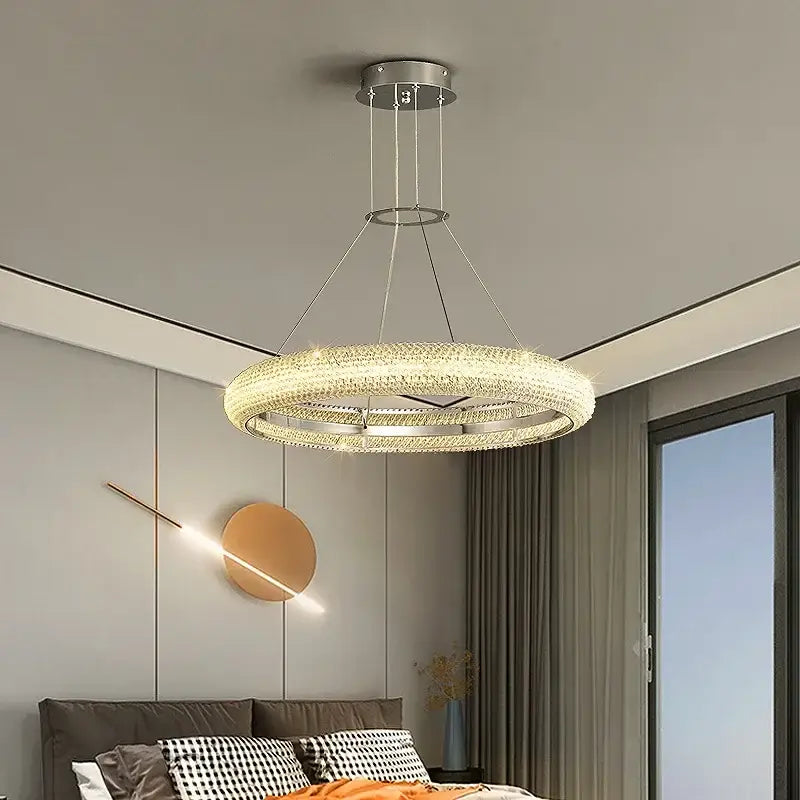 Modern luxury decorbites crystal chandelier with sleek chrome frame and embedded crystals emitting warm LED light