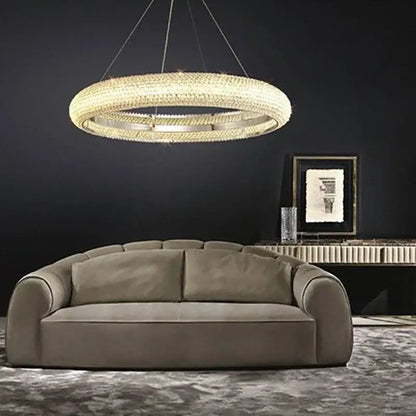 A modern luxury DecorBites crystal chandelier with a gold-toned frame and clear crystals in concentric rings
