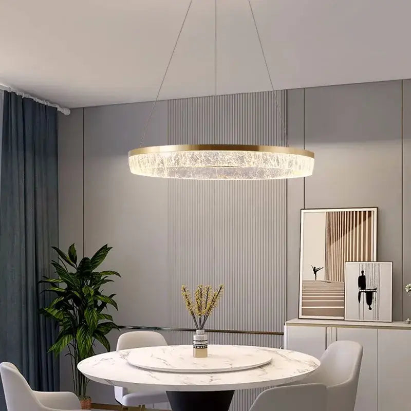 Modern circular pendant light with gold-toned metal frame and translucent crystal rings decorbites crystal chandelier