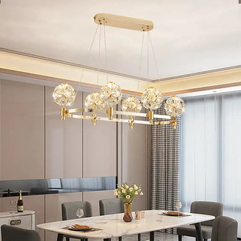 Gold-toned decorbites crystal chandelier with dandelion-like crystal globe pendants for luxe living spaces