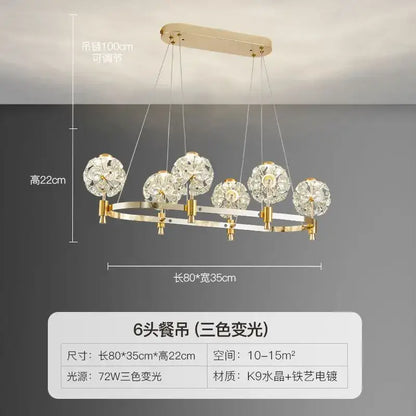 Gold-toned decorbites crystal chandelier with six crystal globe shades and sleek k9 crystal frame for luxe living spaces