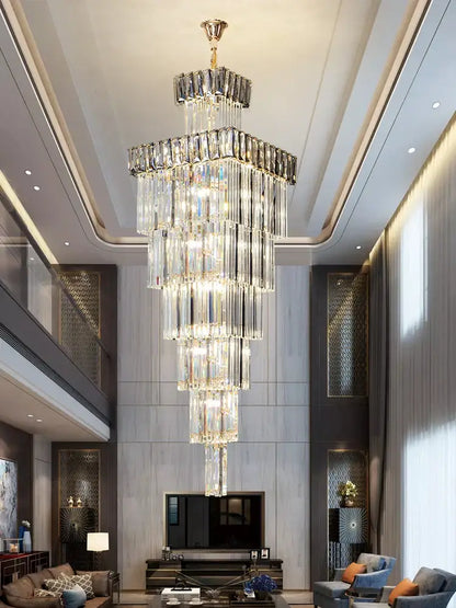 DecorBites crystal chandelier with gold-toned top and cascading clear glass prisms for duplex villa spiral staircase