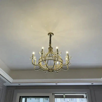 A gold-toned decorbites crystal chandelier with crystal accents and lit bulbs for living and dining rooms
