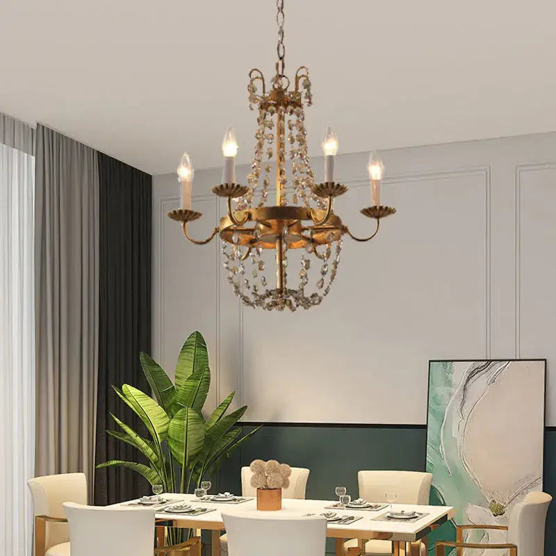 Antique brass decorbites crystal chandelier with dangling crystal droplets and candle-style bulbs for elegant spaces