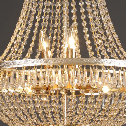 Golden decorbites crystal chandelier with cascading clear beads and teardrop crystals on an ornate silver frame