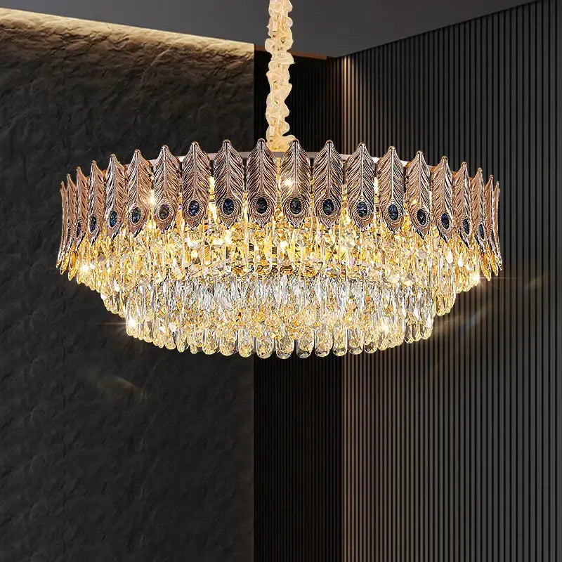 Golden peacock feather-themed decorbites crystal chandelier with cascading teardrop crystals and dark blue gemstones for elegant lighting