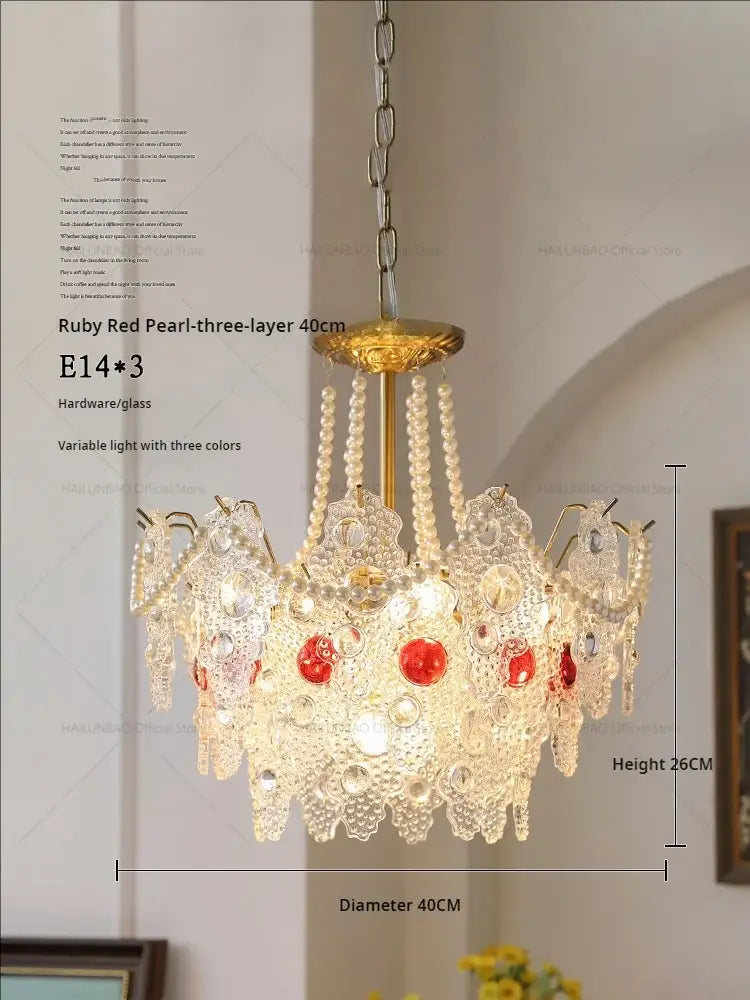 Elegant gold-toned decorbites crystal chandelier with intricate crystal lace and ruby red pearl accents for retro lighting